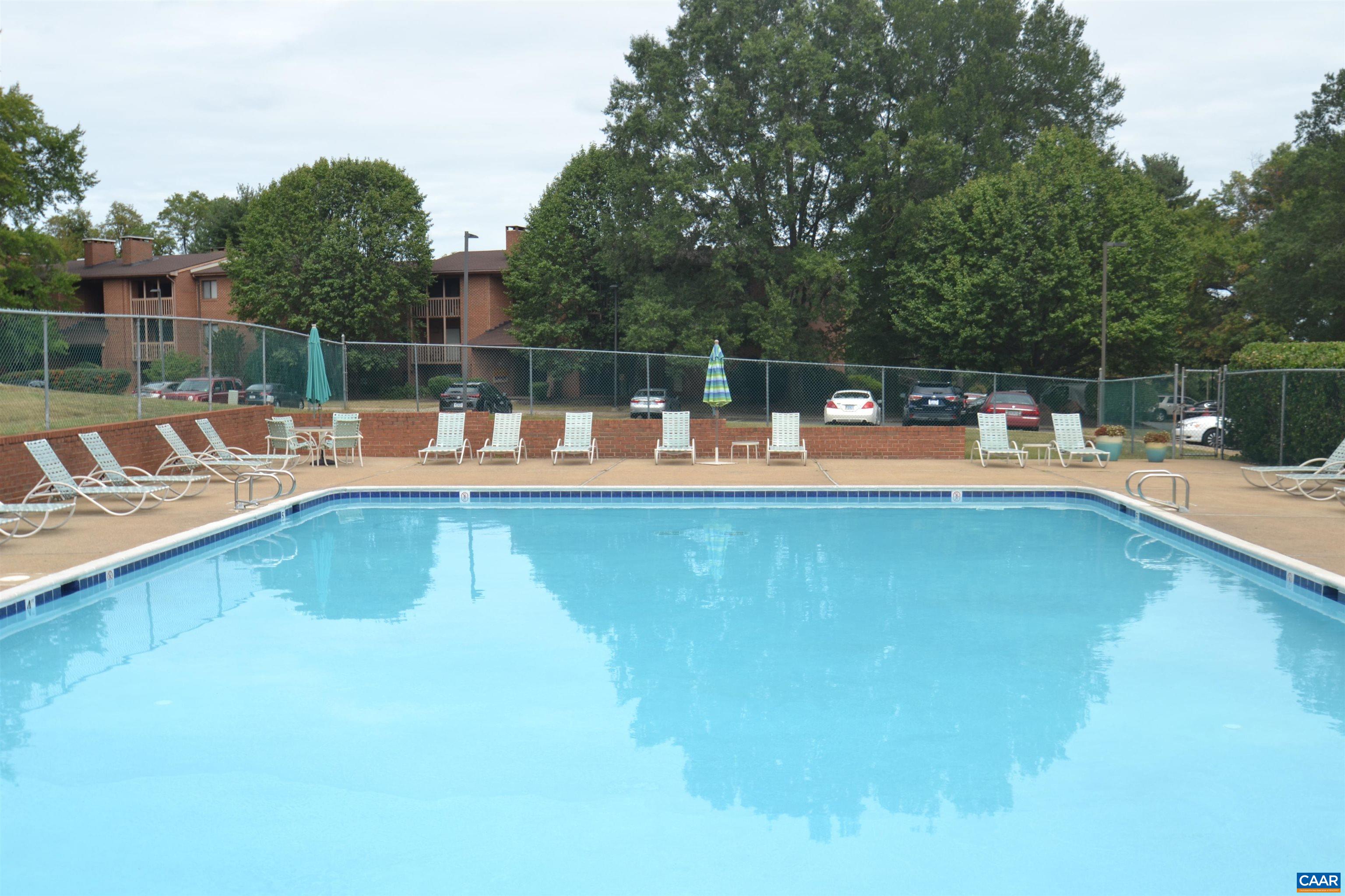116 Turtle Creek Road, Unit 2 Charlottesville, VA 22901 - Photo 39 of 39 a view of a swimming pool with a bench and trees
