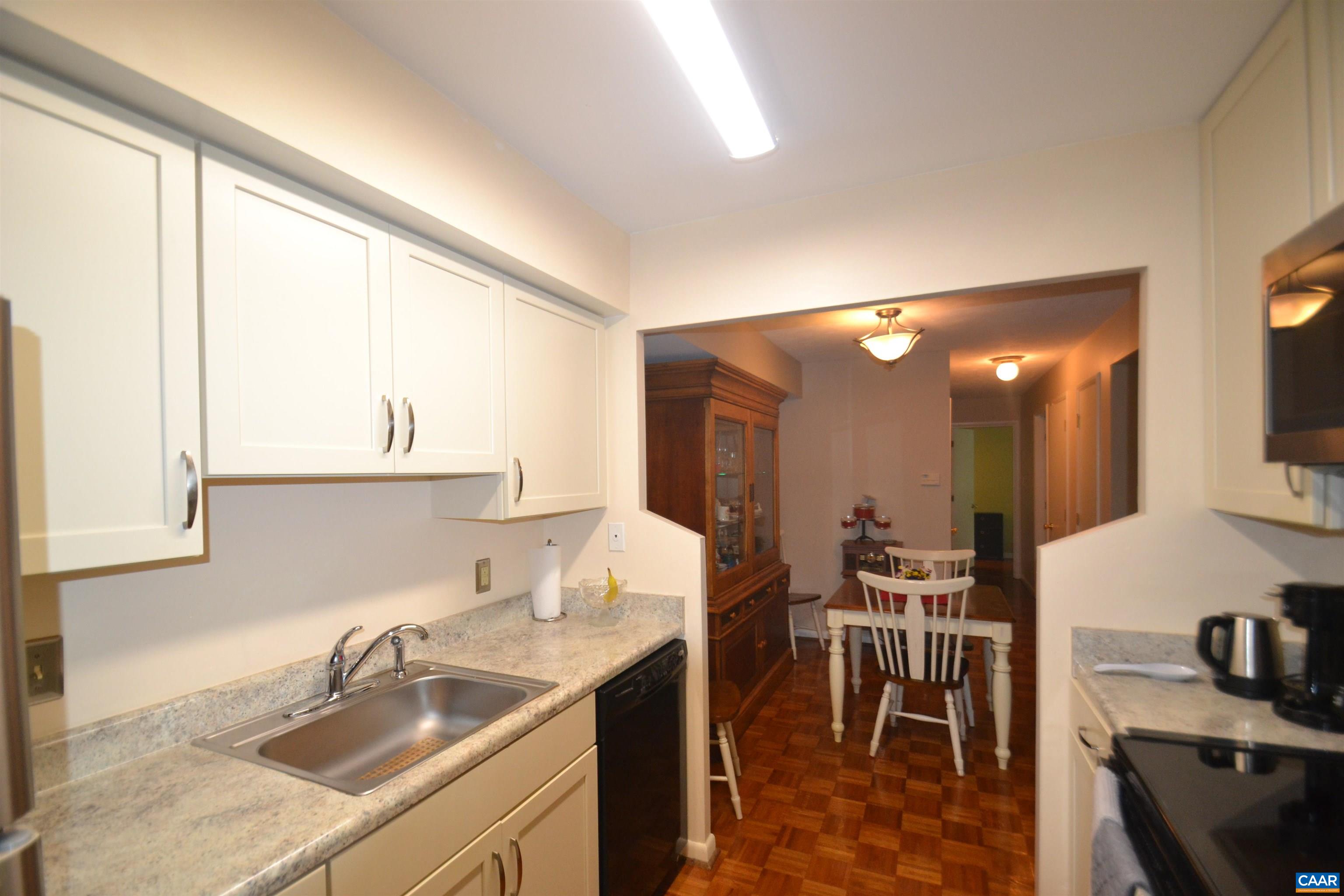 116 Turtle Creek Road, Unit 2 Charlottesville, VA 22901 - Photo 7 of 39 a kitchen with a sink cabinets and dining table chair