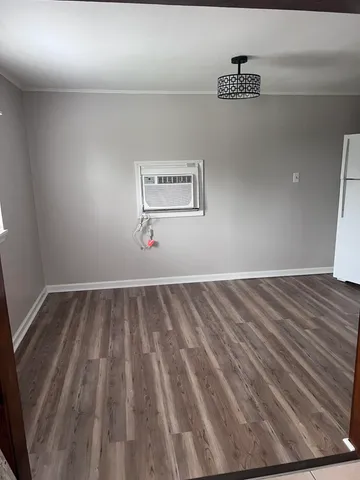 a view of a room with wooden floor