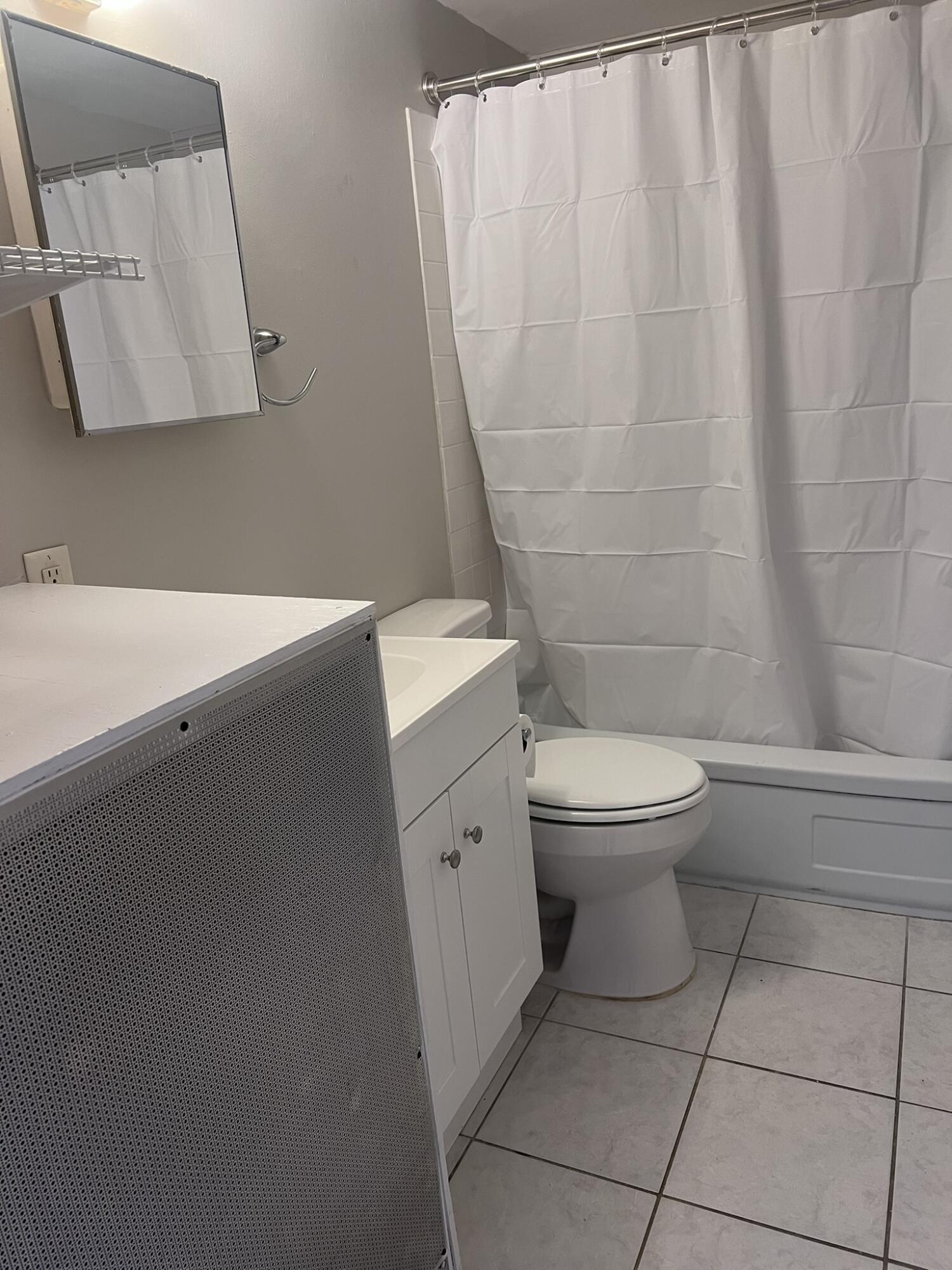 351 Alabama Street Crestview, FL 32536 - Photo 9 of 9 a white toilet sitting next to a white sink and vanity
