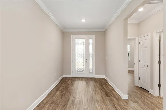 a view of a kitchen with a sink and wooden floor