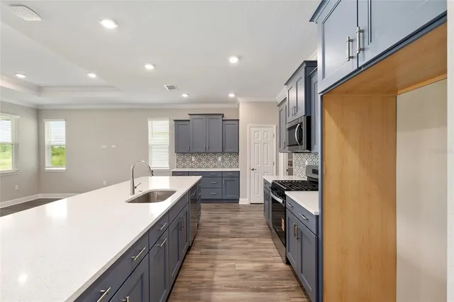 a kitchen with counter top space sink and center island