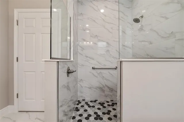 a bathroom with a granite countertop sink a toilet and shower