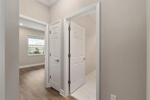 a view of room with wooden floor and bathroom