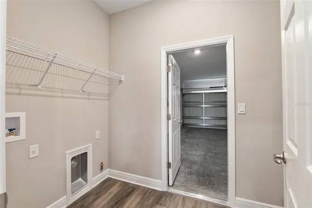 a front view of a house with yard and lake view