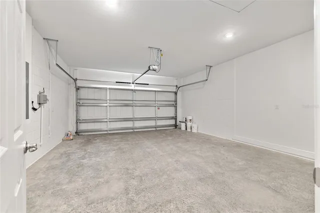 a front view of a house with swimming pool and porch with furniture