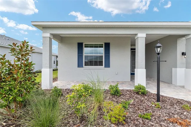 a view of a porch with furniture and a yard