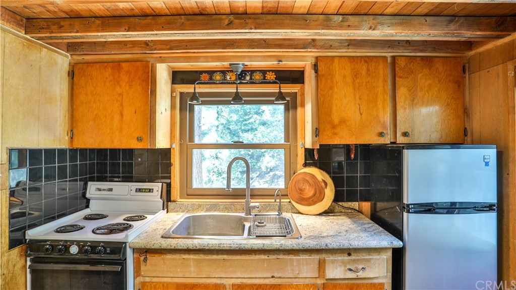 34 Manker Flats Mt Baldy, CA 91759 - Photo 10 of 30 a kitchen with a sink and a stove next to a window