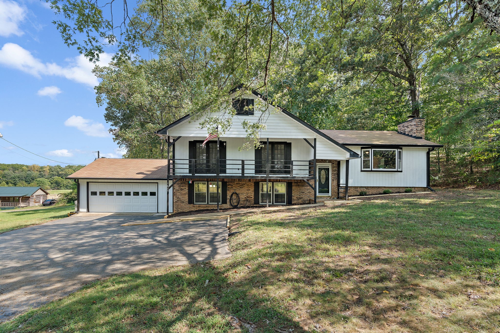a view of a house with a yard and sitting area