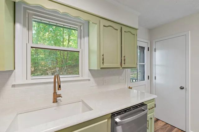 a kitchen with a sink and a window
