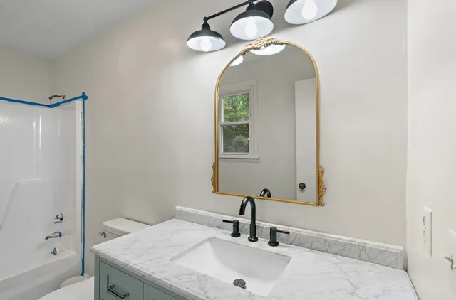 a bathroom with a sink and a mirror