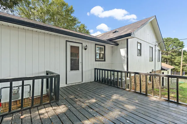 a view of a house with a wooden deck