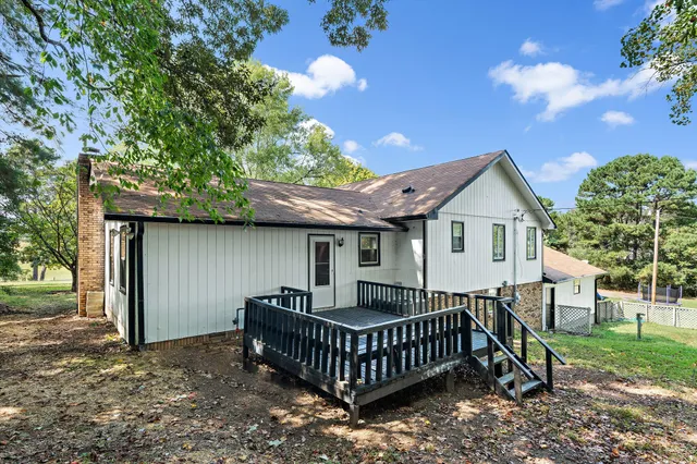 a front view of a house with garden and deck