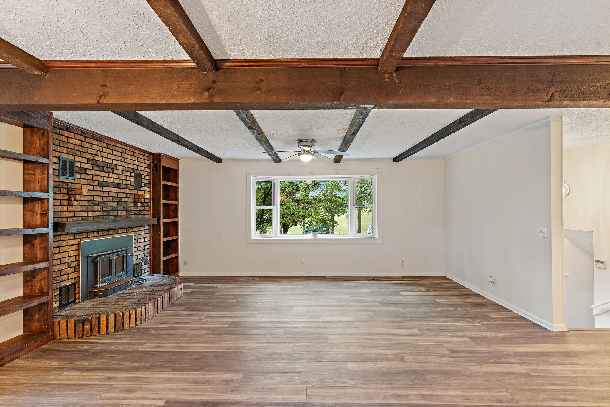 1627 West Grab Creek Road Dickson, TN 37055 - Photo 4 of 46 a view of empty room with wooden floor and fan