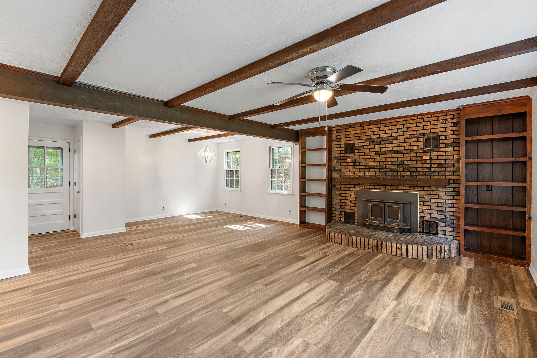 1627 West Grab Creek Road Dickson, TN 37055 - Photo 6 of 46 a view of empty room with wooden floor and fireplace