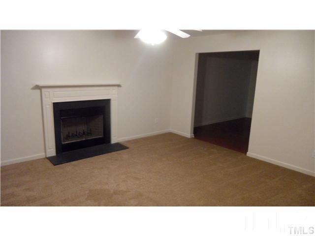 6610 Frogstool Lane Raleigh, NC 27610 - Photo 2 of 11 a open living room with a fireplace
