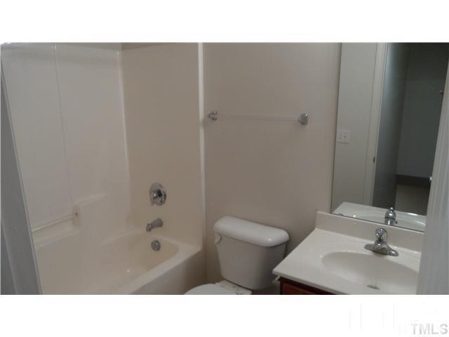 6610 Frogstool Lane Raleigh, NC 27610 - Photo 11 of 11 a bathroom with a sink toilet a mirror and shower