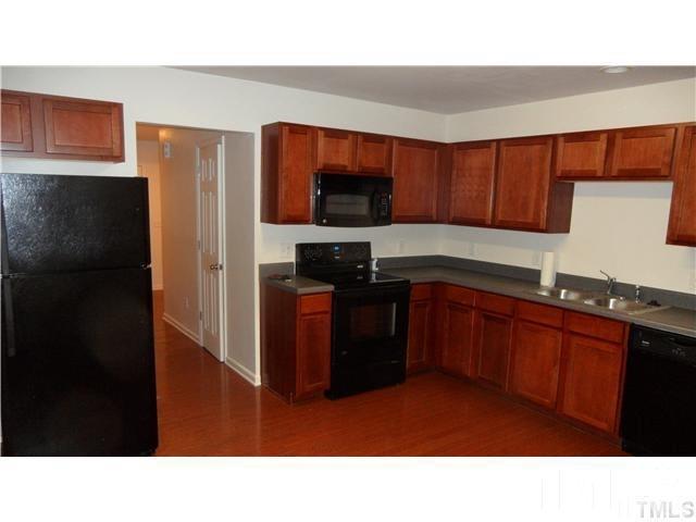 6610 Frogstool Lane Raleigh, NC 27610 - Photo 3 of 11 a kitchen with a refrigerator and a sink
