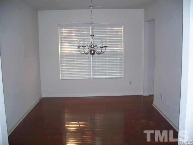 6610 Frogstool Lane Raleigh, NC 27610 - Photo 5 of 11 a view of empty room with wooden floor and fan