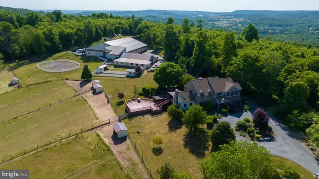 an aerial view of a house with a garden and swimming pool