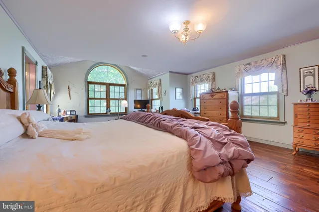 a bed room with a bed and a chair