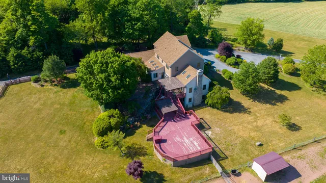 an aerial view of a house with yard swimming pool and outdoor seating