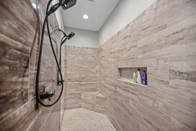 a view of walk in closet with clothes