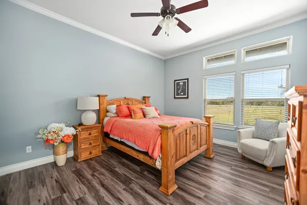 a living room with furniture a flat screen tv and potted plants