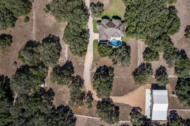 an aerial view of a house with a yard