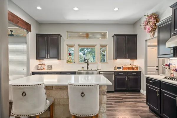 a kitchen with a sink stove and cabinets