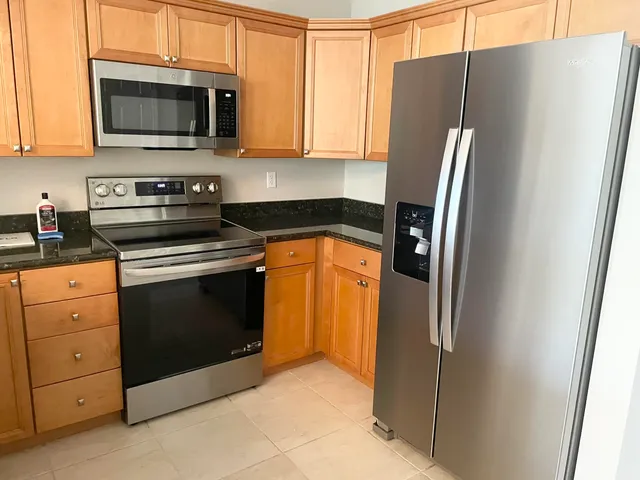 a kitchen with stainless steel appliances a refrigerator stove and microwave