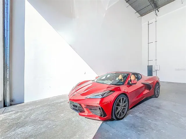 a bedroom with a bed and a car