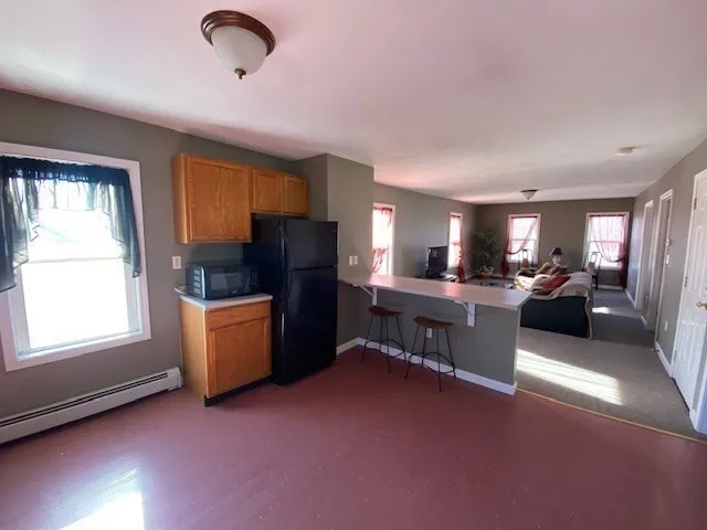 a living room with furniture flat screen tv and window