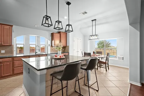 a kitchen with a dining table and chairs
