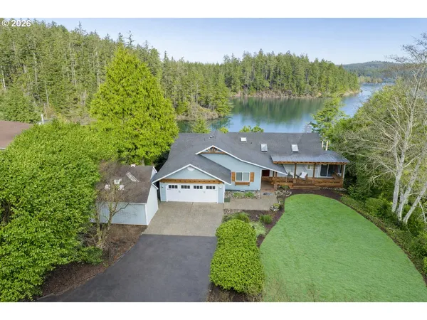 a aerial view of a house with pool and a yard