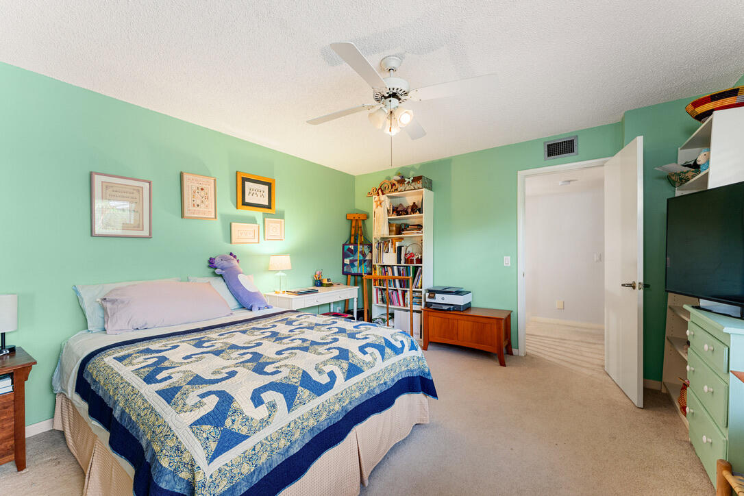 4102 Roxbury Court, Unit 41B Boynton Beach, FL 33436 - Photo 16 of 24 a bedroom with a bed and a flat tv screen