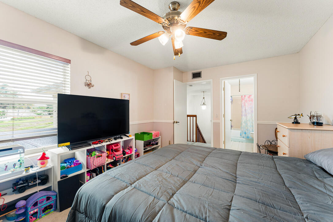 4102 Roxbury Court, Unit 41B Boynton Beach, FL 33436 - Photo 21 of 24 a bedroom with a bed and a flat screen tv