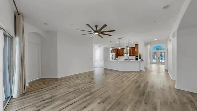 a view of a livingroom with a kitchen and wooden floor