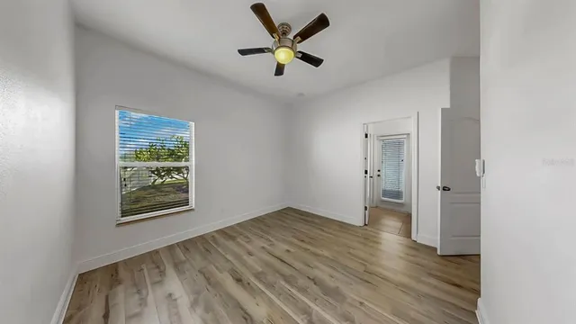 wooden floor in an empty room with a window