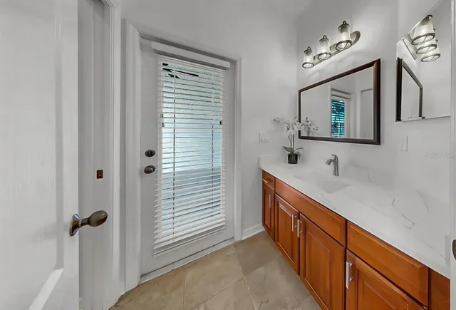 a bathroom with a sink a mirror and shower