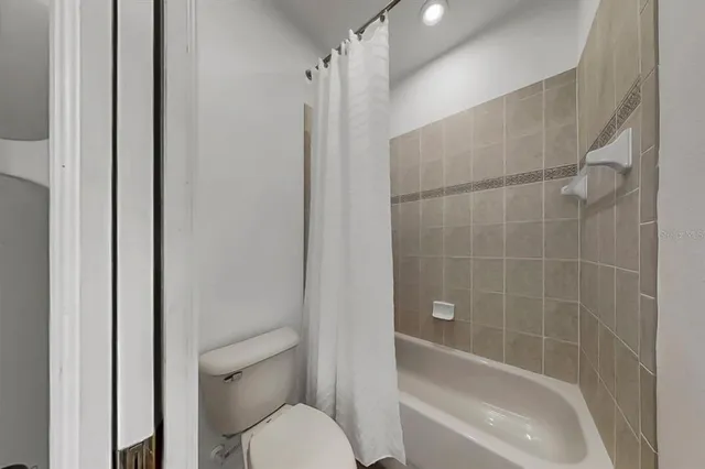 a bathroom with a toilet and shower