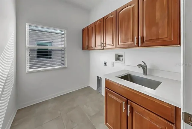 a kitchen with stainless steel appliances granite countertop white cabinets and a sink