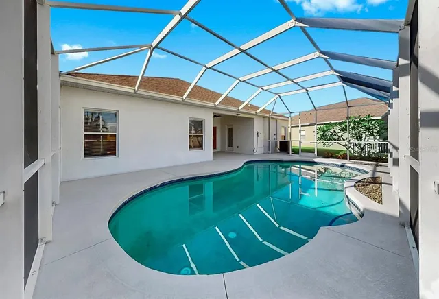 a swimming pool with outdoor seating