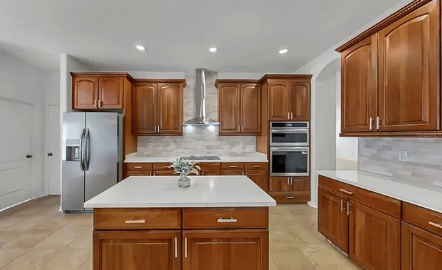 a kitchen with a stove and a refrigerator