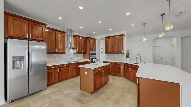 a kitchen with stainless steel appliances granite countertop a sink counter space cabinets and stainless steel appliances