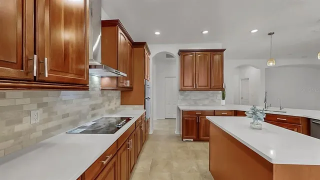 a kitchen with a sink stove and cabinets