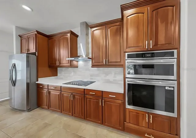 a kitchen with granite countertop stainless steel appliances and cabinets