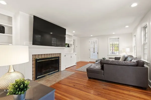 a living room with furniture a flat screen tv and a fireplace