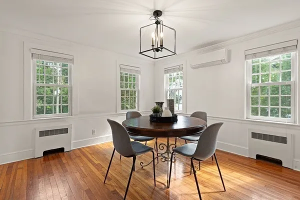 a view of a dining room with furniture window and wooden floor