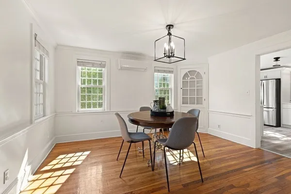a view of a dining room with furniture window and wooden floor